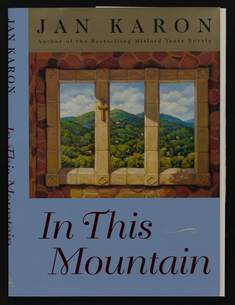 Dust jacket: Jan Karon, In This Mountain. Painting on cover shows view through stone window toward wooded mountains